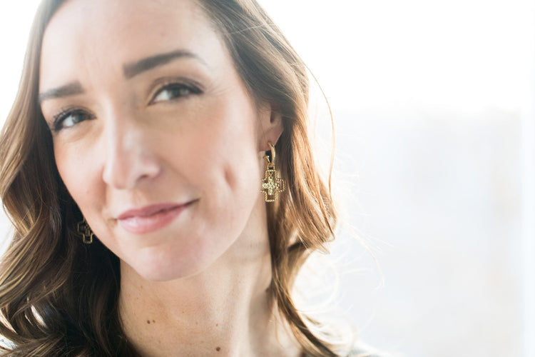cross earrings left ear