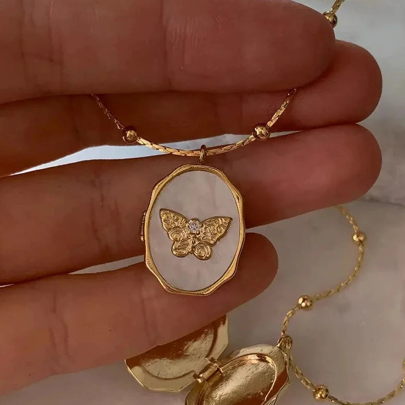 butterfly locket in hand 